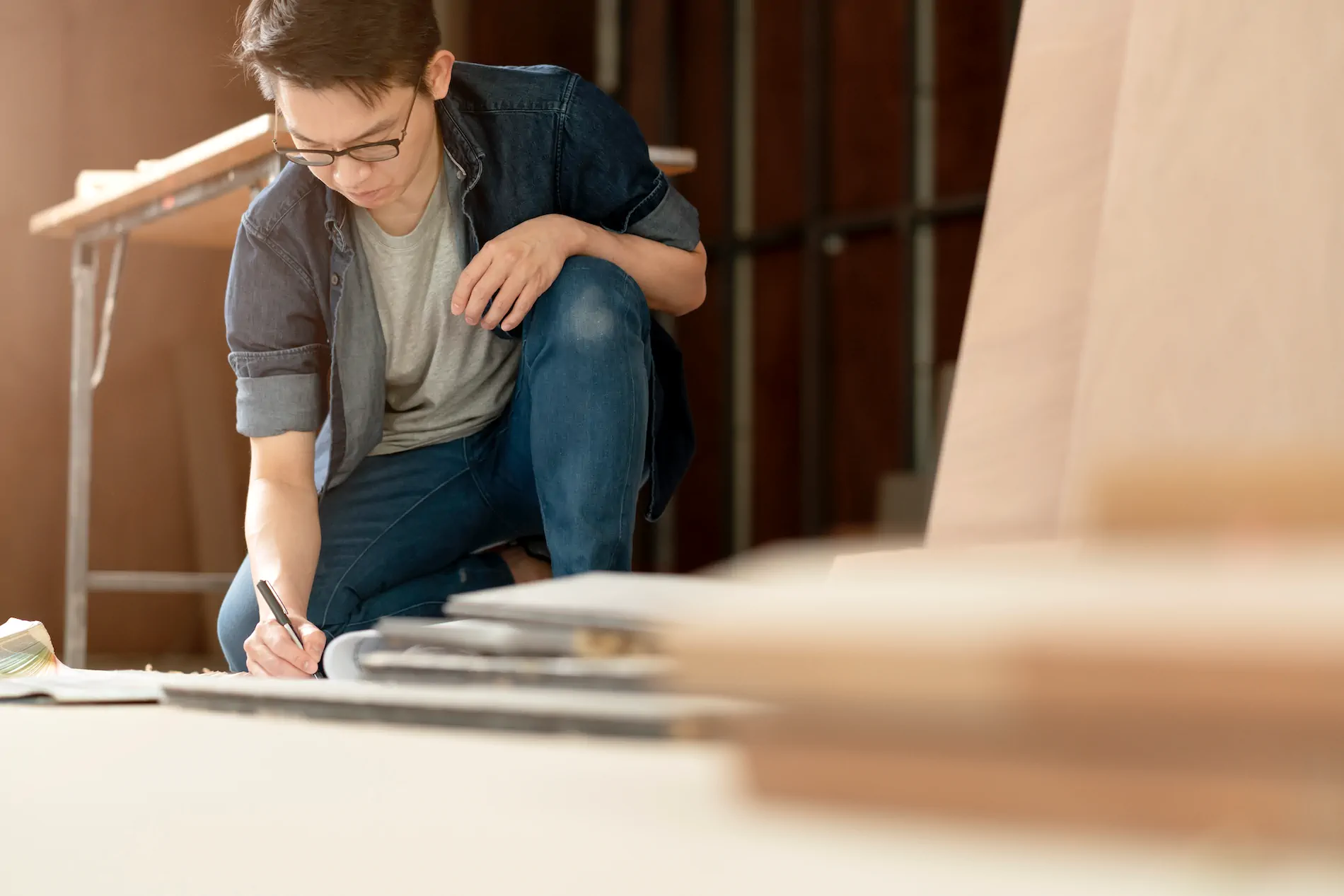 smart attractive glasses male casual costume contractor woodwork site home renovation concept smile confident carpenter contractor site construction background